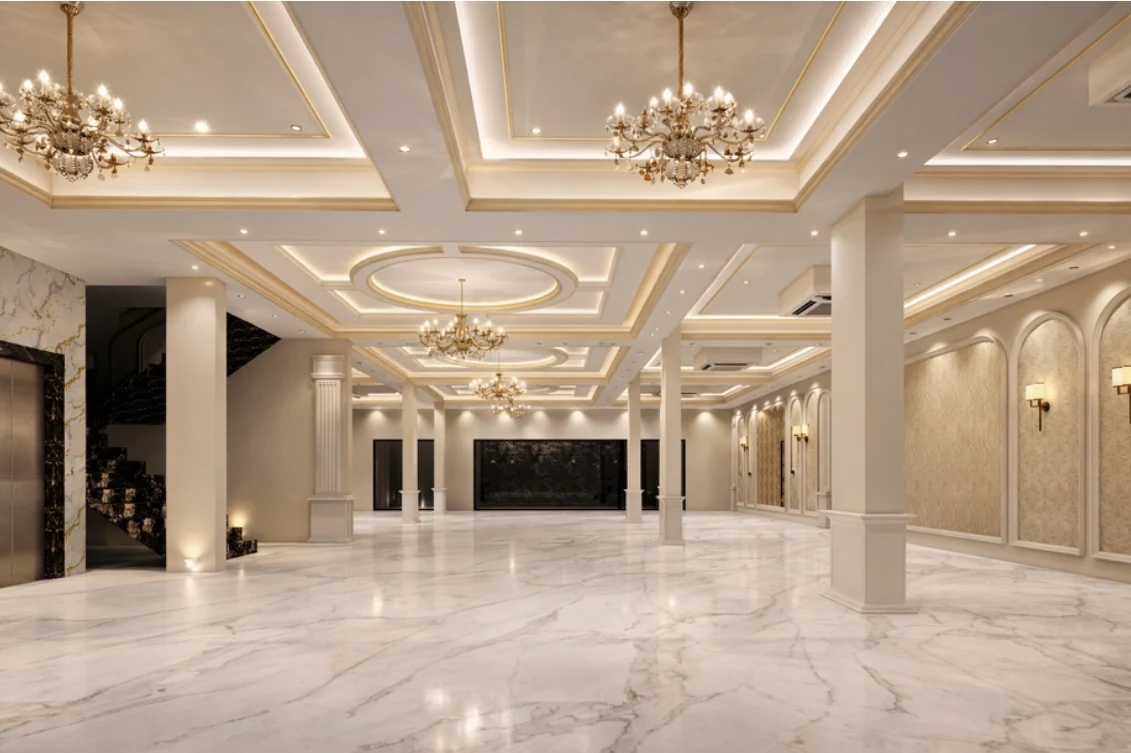 A generous reception space with marble floors and chandeliers