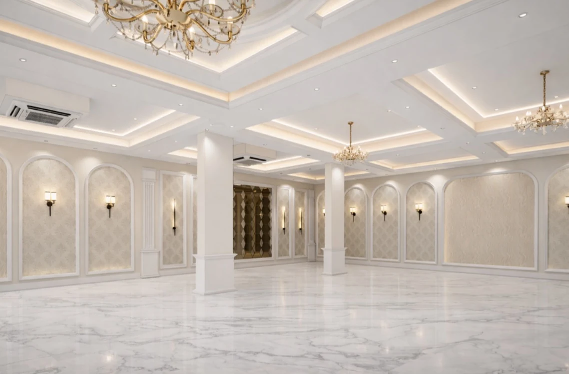 A pale reception space with columns and chandeliers
